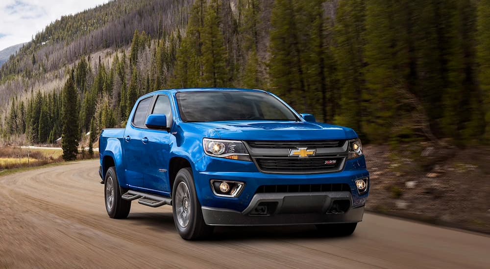 A blue 2020 Chevy Colorado ZR2 driving through the mountains