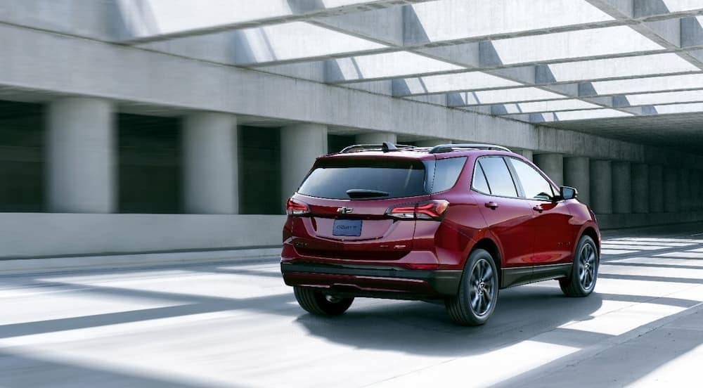 A red 2024 Chevy Equinox is shown driving in a tunnel.
