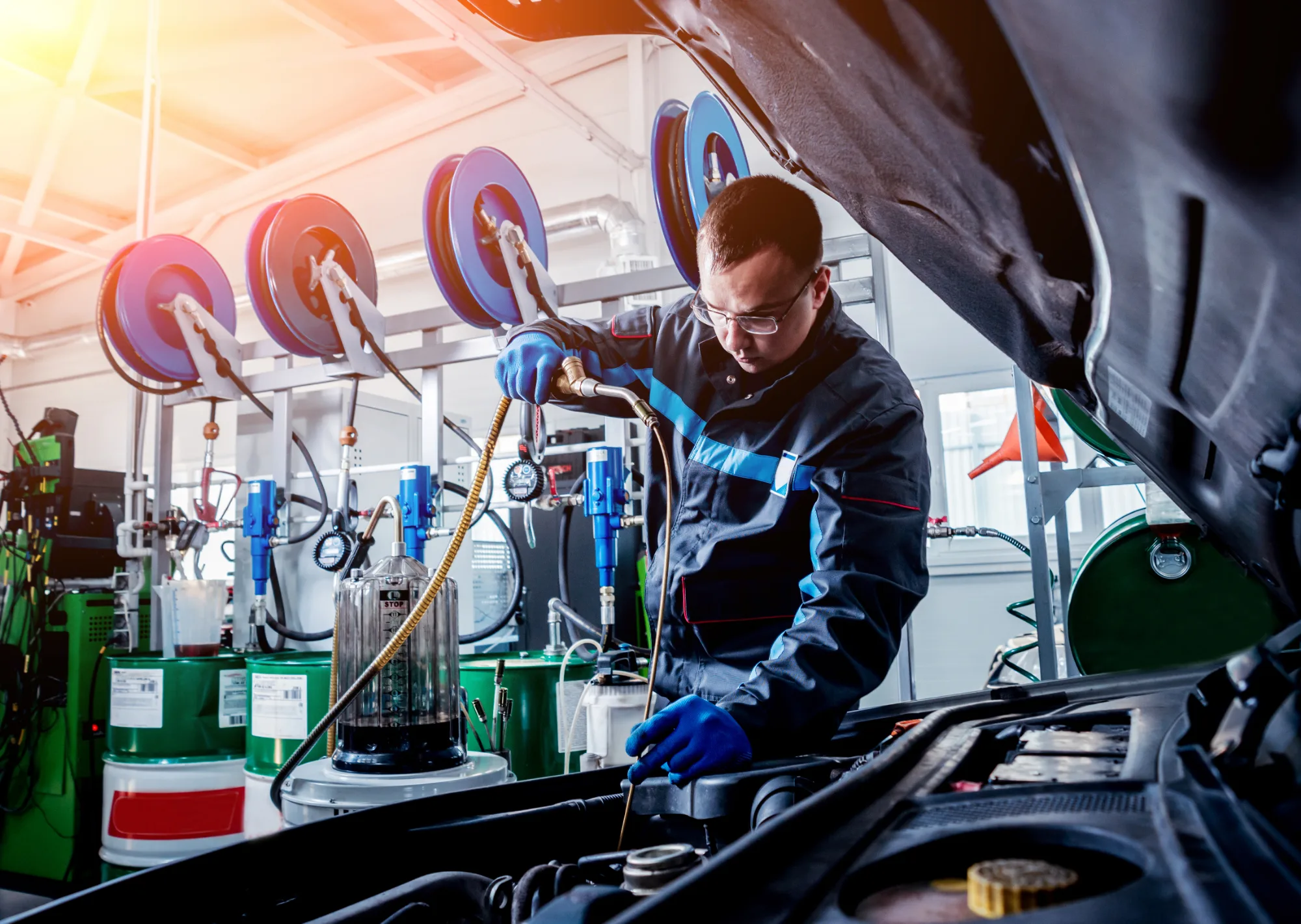 Technician pouring oil in engine