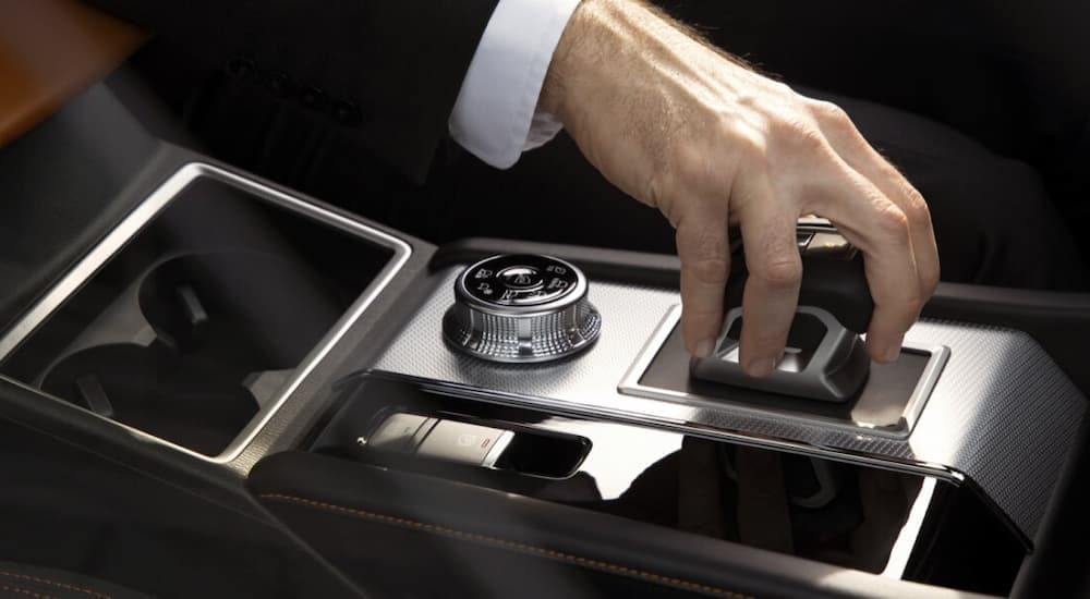 Close up of a man's hand using the shifter in a 2023 Mitsubishi Outlander