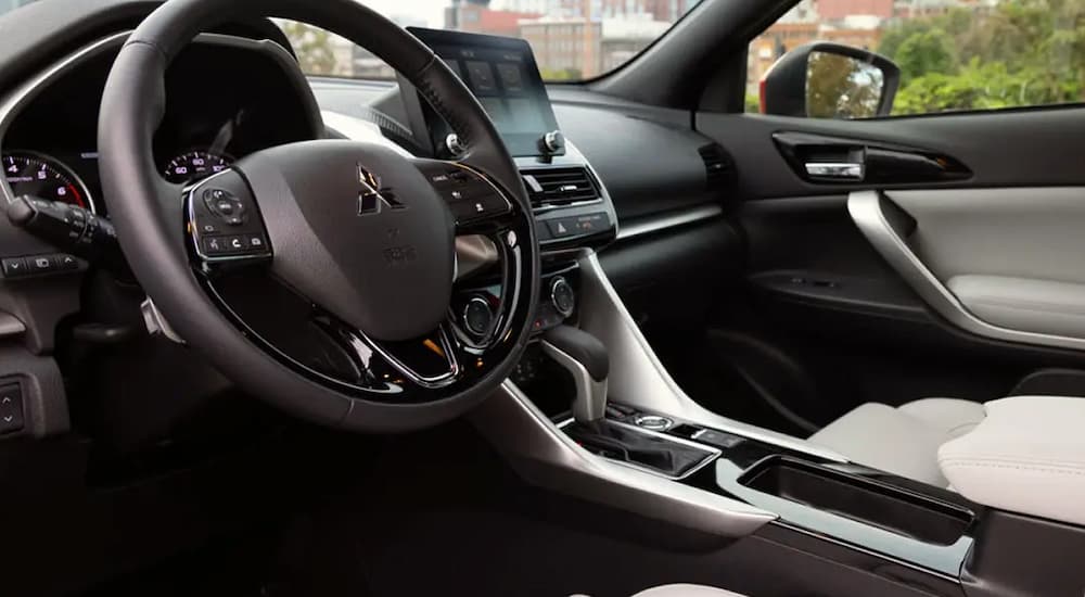 View from the driver's seat of the black and grey interior of a 2023 Mitsubishi Eclipse Cross.