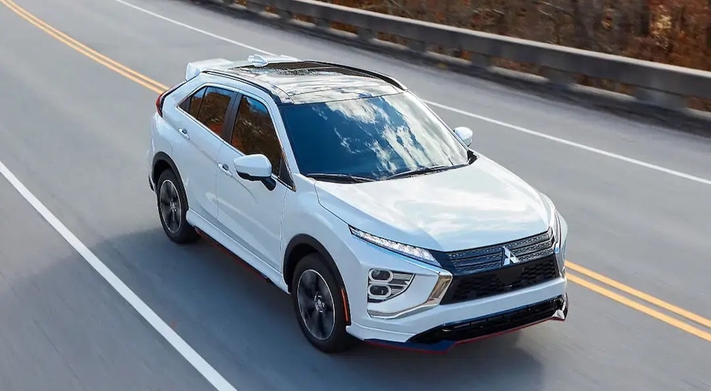 A white 2024 Mitsubishi Eclipse Cross is shown from the front at an angle.