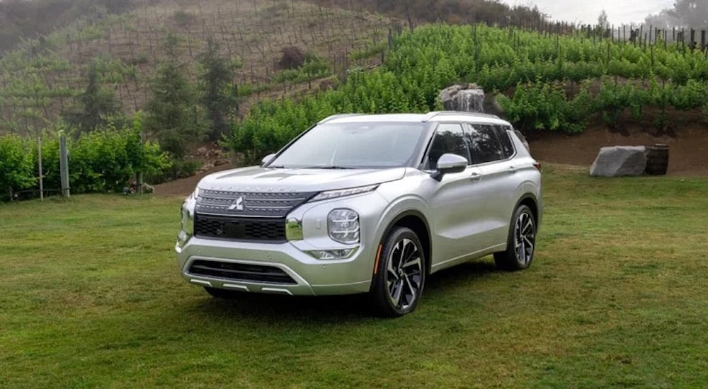 A silver 2024 Mitsubishi Outlander for sale near Wladorf is shown from the front at an angle. is shown 