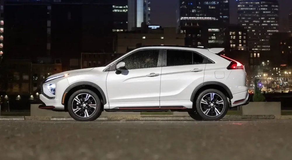 A white 2024 Mitsubishi Eclipse Cross for sale near Waldorf is shown from the side.