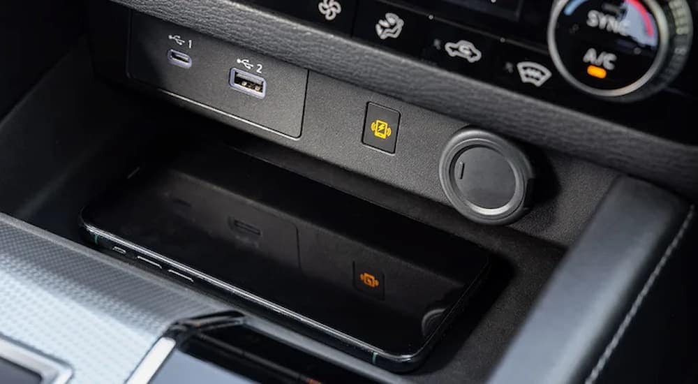 A close up of the phone charging area in the center console of a 2024 Mitsubishi Outlander.