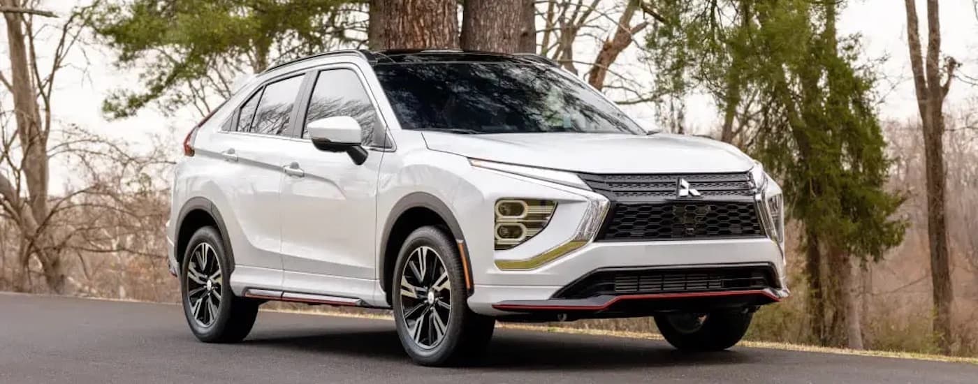 A white 2024 Mitsubishi Eclipse Cross is shown from the front at an angle.