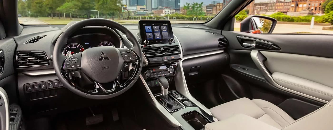 The tan interior of a 2024 Mitsubishi Eclipse Cross is shown from the drivers seat.
