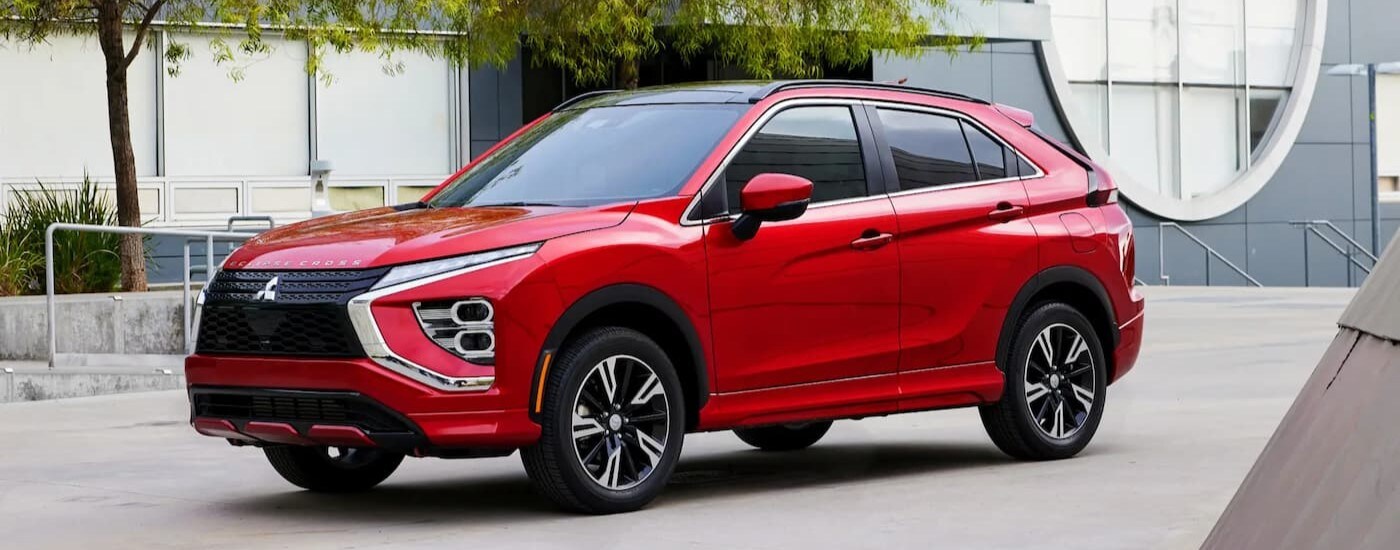 A red 2024 Mitsubishi Eclipse Cross for sale is shown parked.