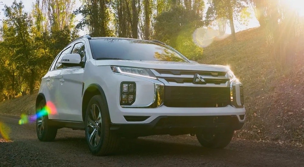 A white 2024 Mitsubishi Outlander Sport for sale near Alexandria is shown from the front at an angle.
