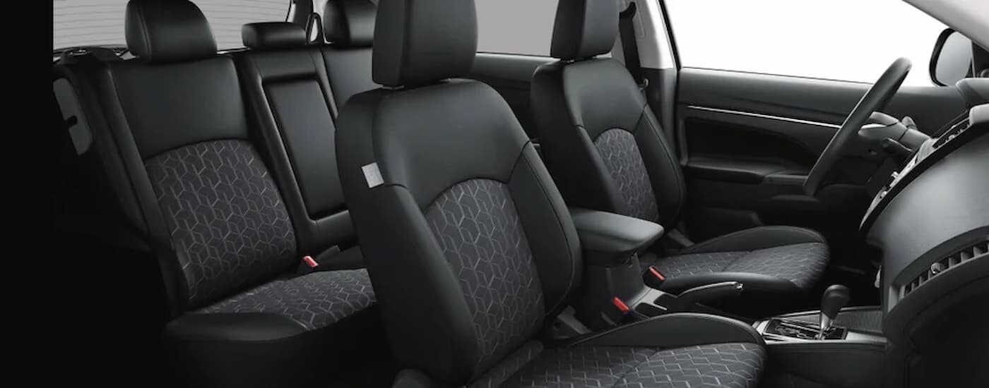 The black interior and dash in a 2024 Mitsubishi Outlander Sport is shown.