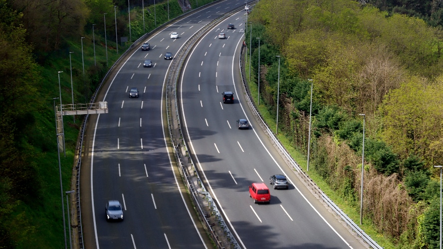 An overhead view of vehicles driving on the highway.