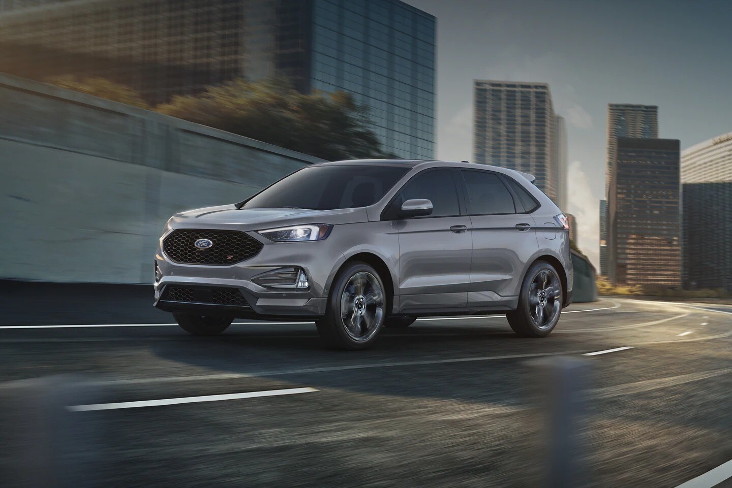 New Ford Edge in gray driving on the highway in the city