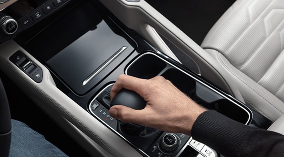 Compare the 2021 Kia Telluride vs. the 2021 Honda Pilot at West Broad Kia | Guy using shifter