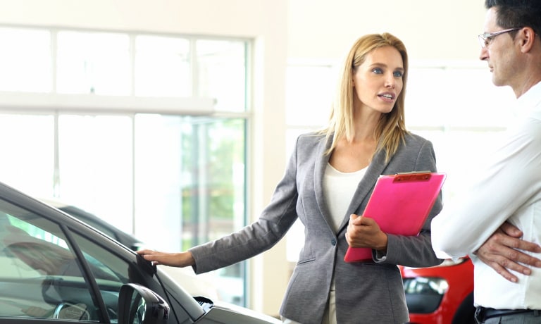 Customer looking at a new car New car shopping