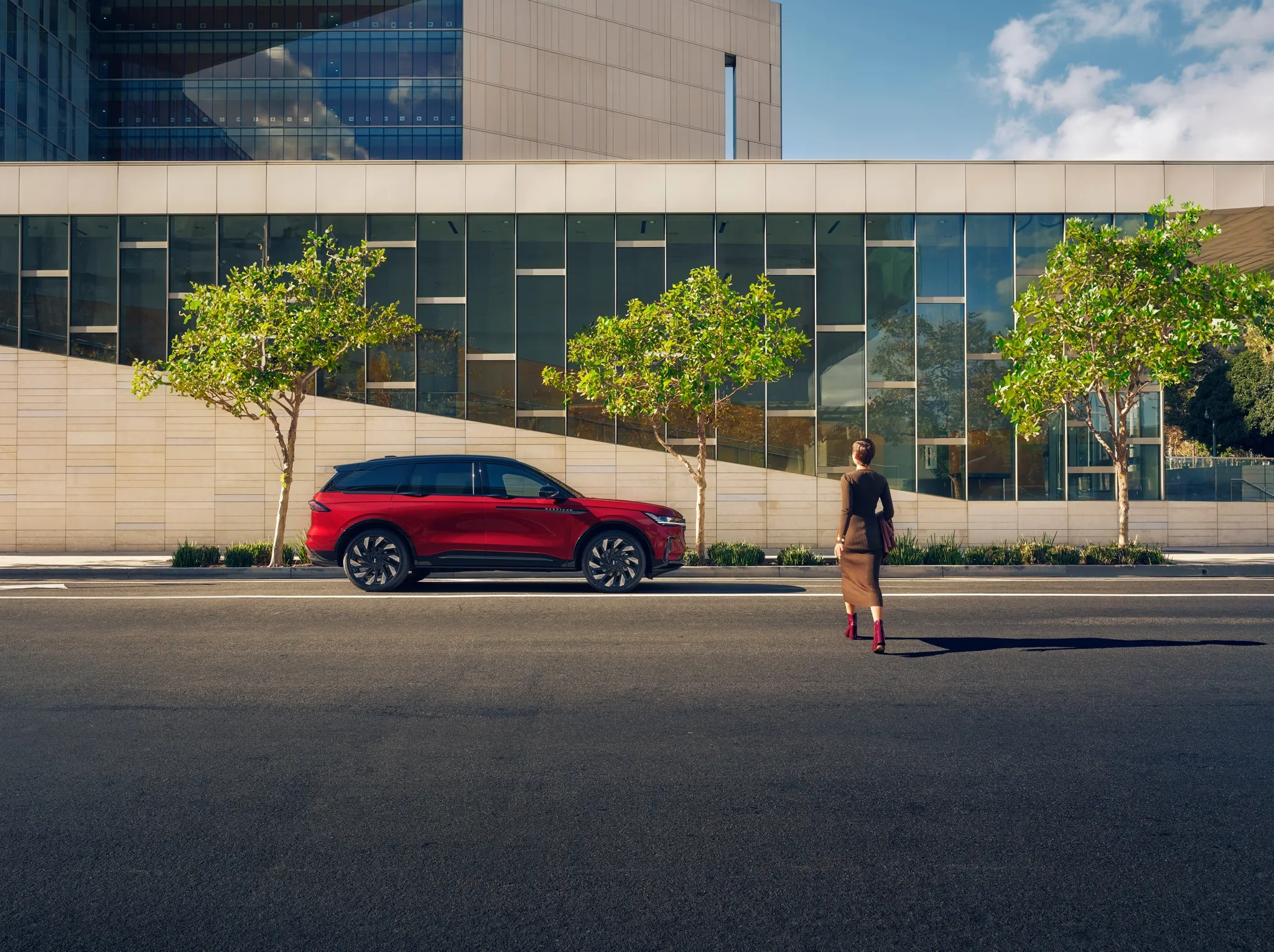 Woman approaching 2026 Lincoln Nautilus with Lincoln Embrace welcome lighting