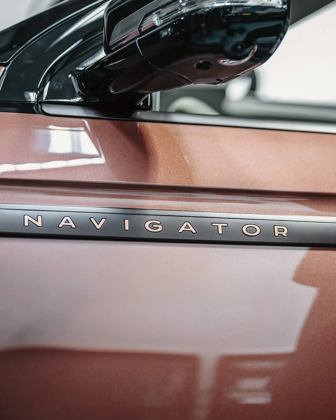 The NAVIGATOR nameplate in gold lettering on the copper door of the Black Label