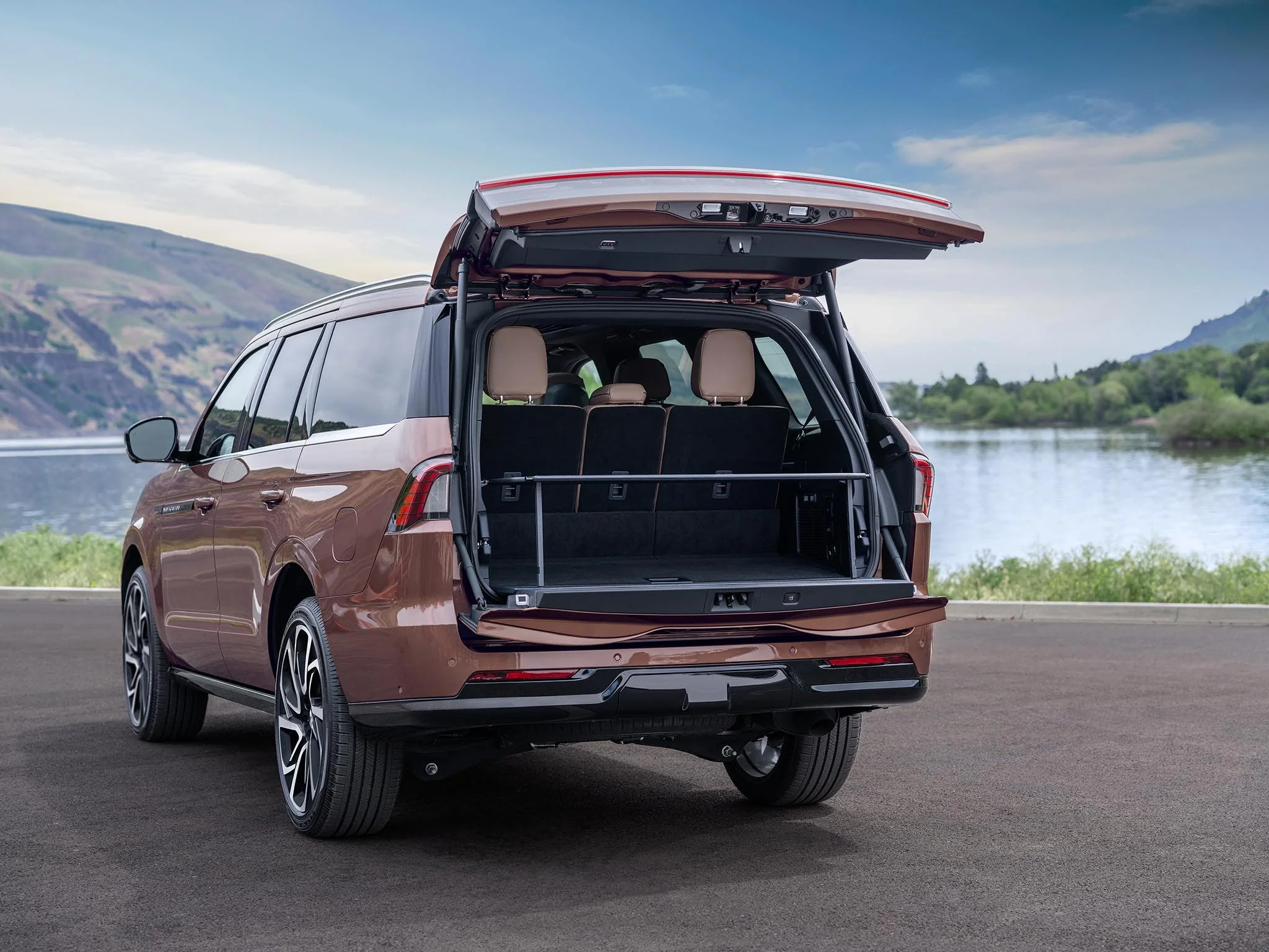 The rear of a Lincoln Navigator with its liftgate open, showing the cargo area and third row