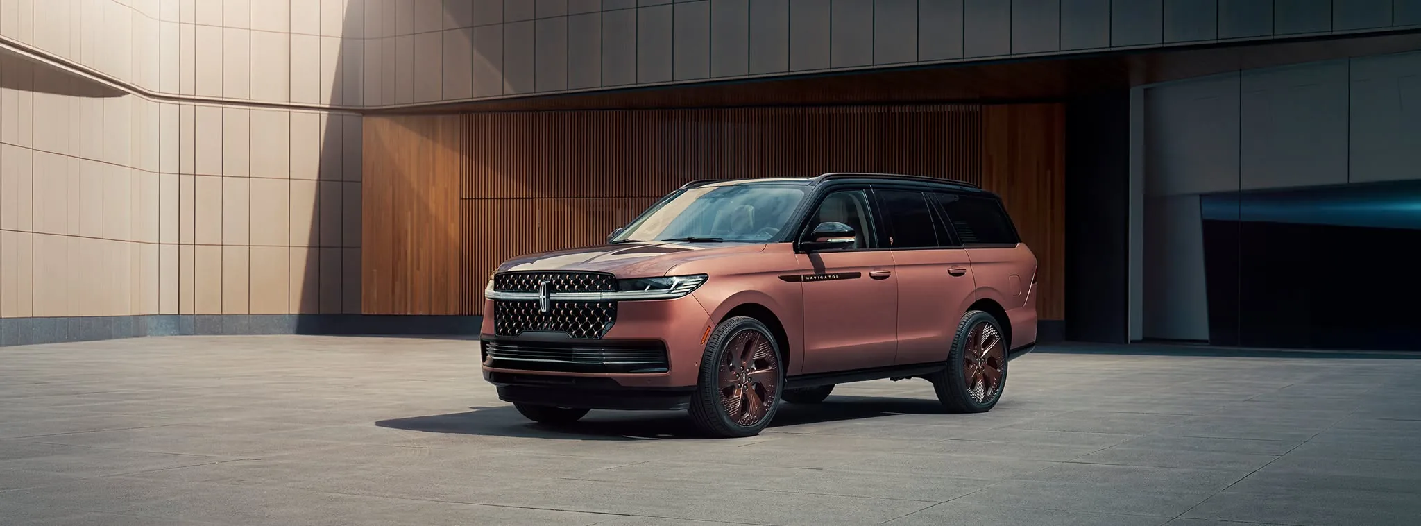 2026 Lincoln Navigator Black Label in a copper Black Label finish parked outside a modern building, full-size three-row luxury SUV, at Parks Lincoln of Longwood serving greater Orlando