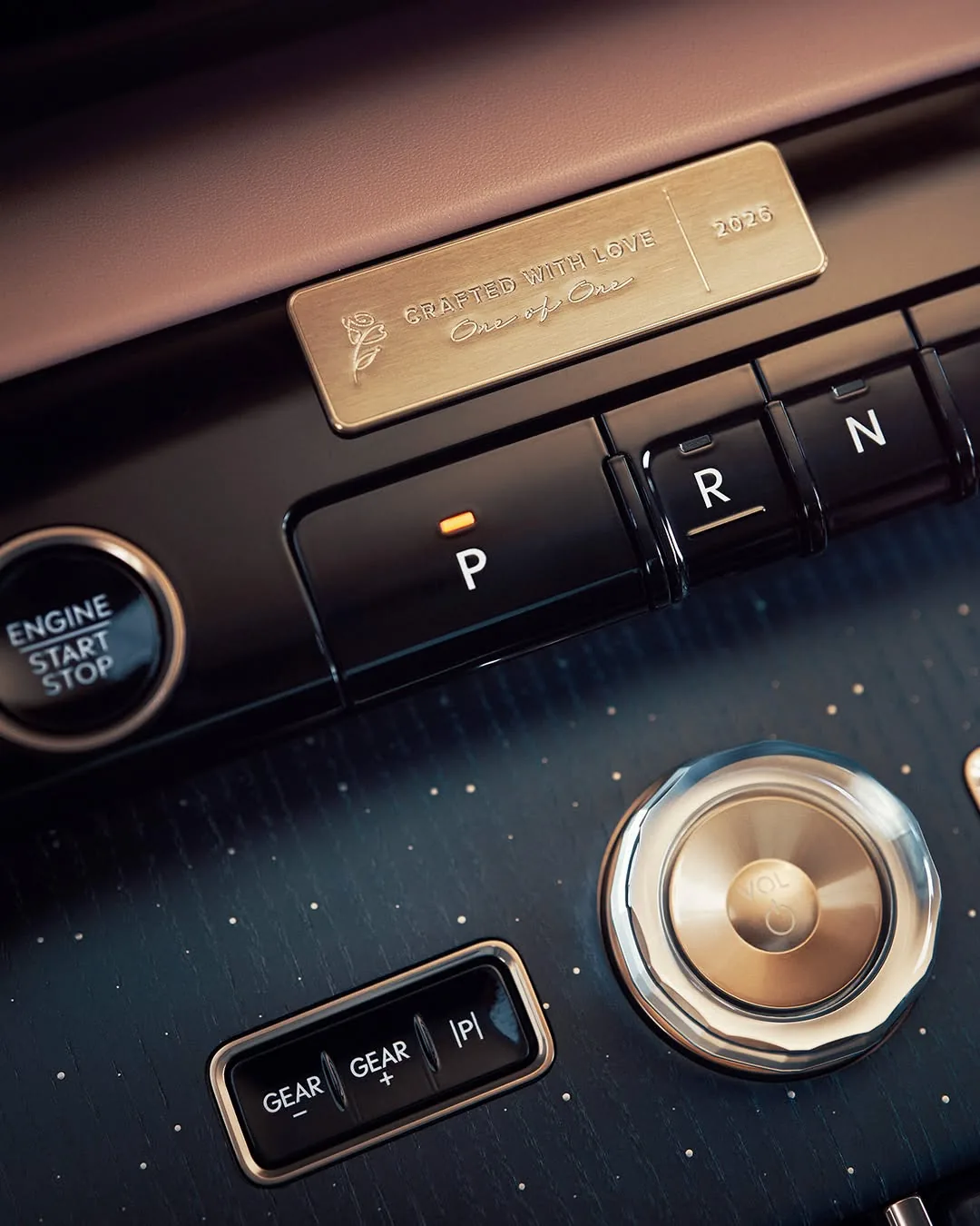 Gold plaque reading Crafted With Love, One of One, 2026 above the Navigator gear controls and crystal volume knob