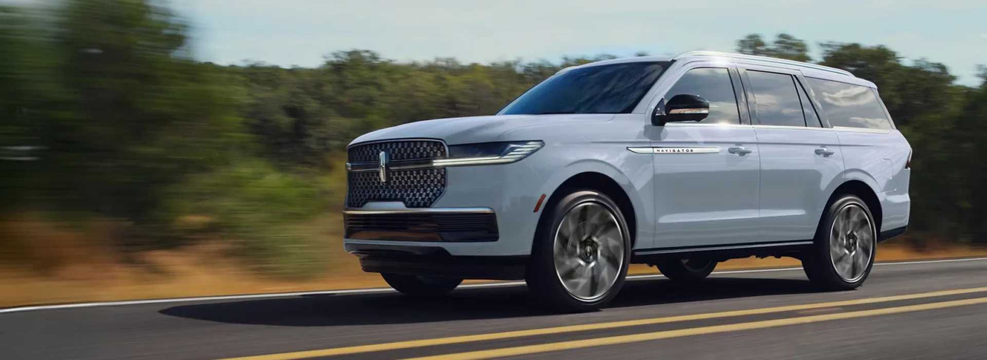 2027 Lincoln Navigator driving on a mountain highway