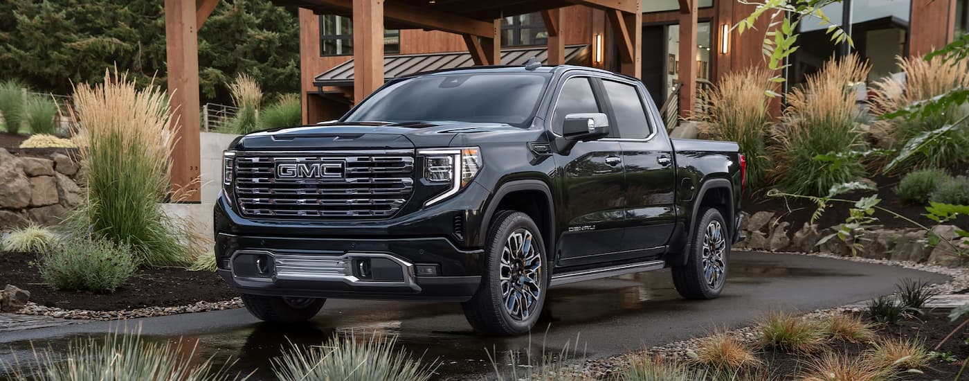 Black 2026 GMC Sierra 1500 parked in front of a building.