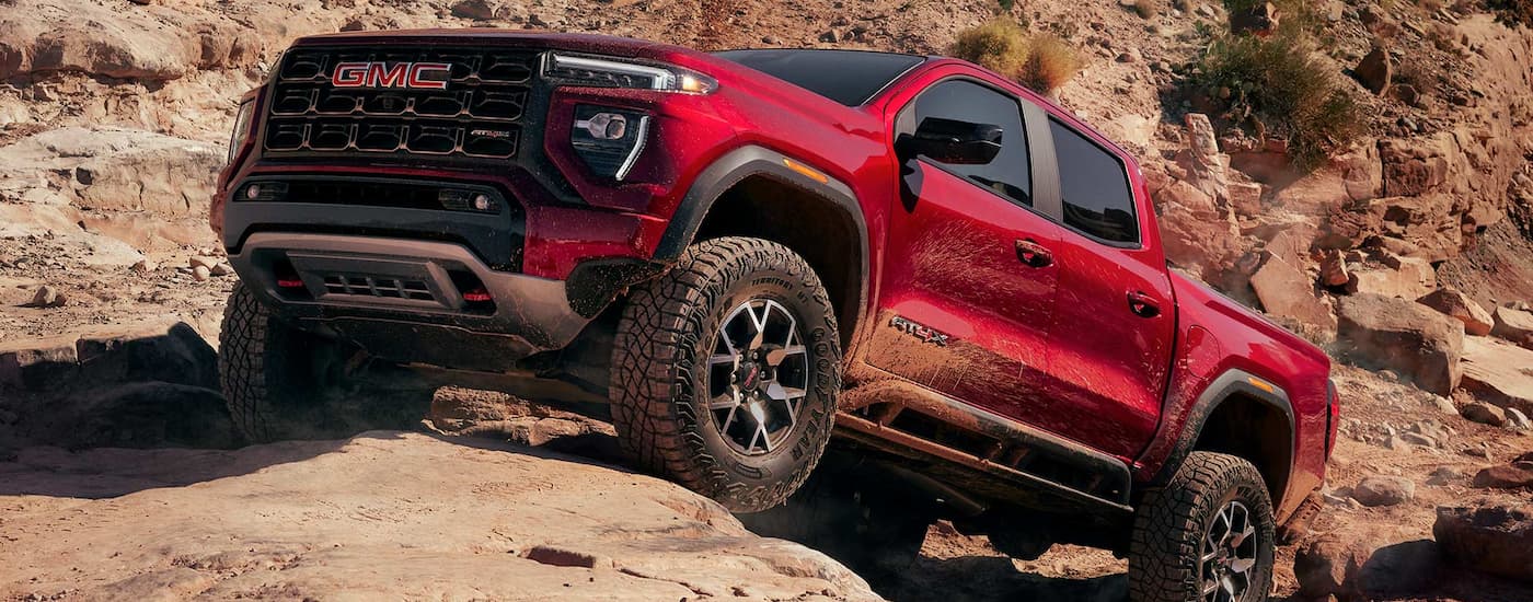 Low angle view of a 2026 GMC Canyon parked off-road on a hill.
