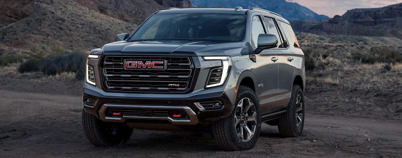 Silver 2026 GMC Yukon parked off-road.