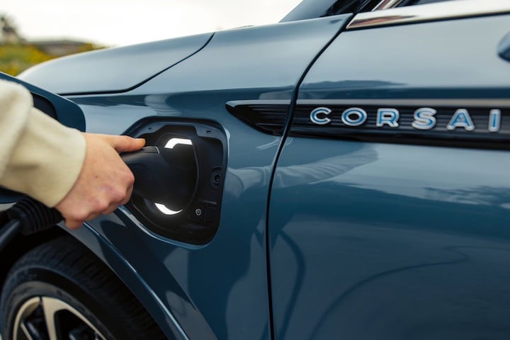 Someone charing the Lincoln Corsair Hybrid vehicle.