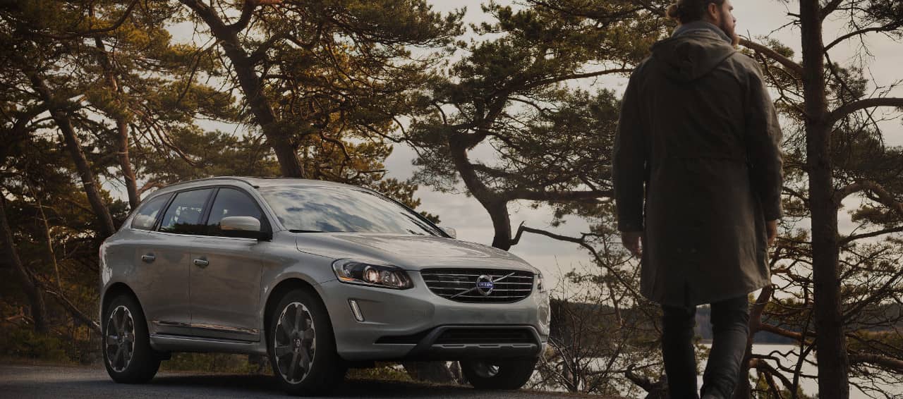 man walks to Volvo SUV