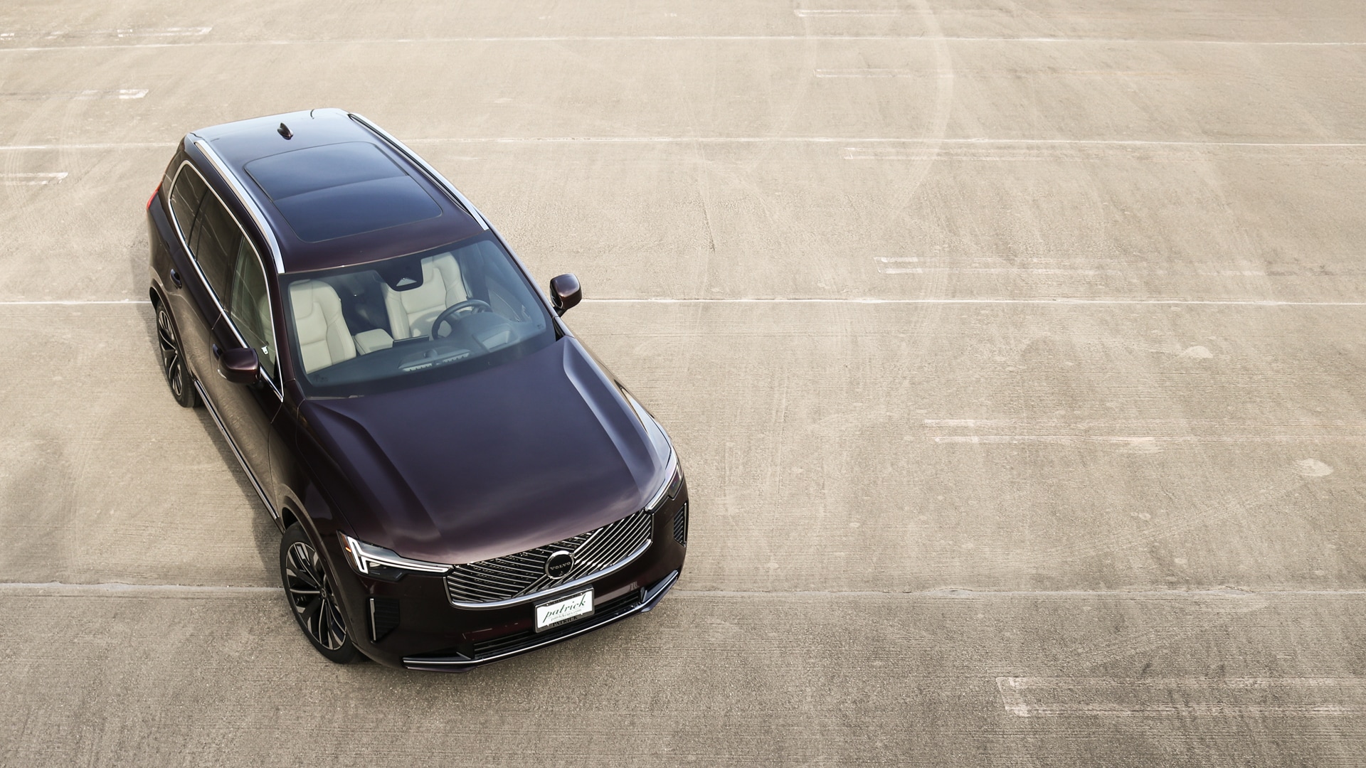 Top-down view of the 2025.5 Volvo XC90 highlighting its panoramic moonroof, sculpted roofline, and sleek aerodynamic profile-emphasizing the SUV's modern design and spacious three-row layout.