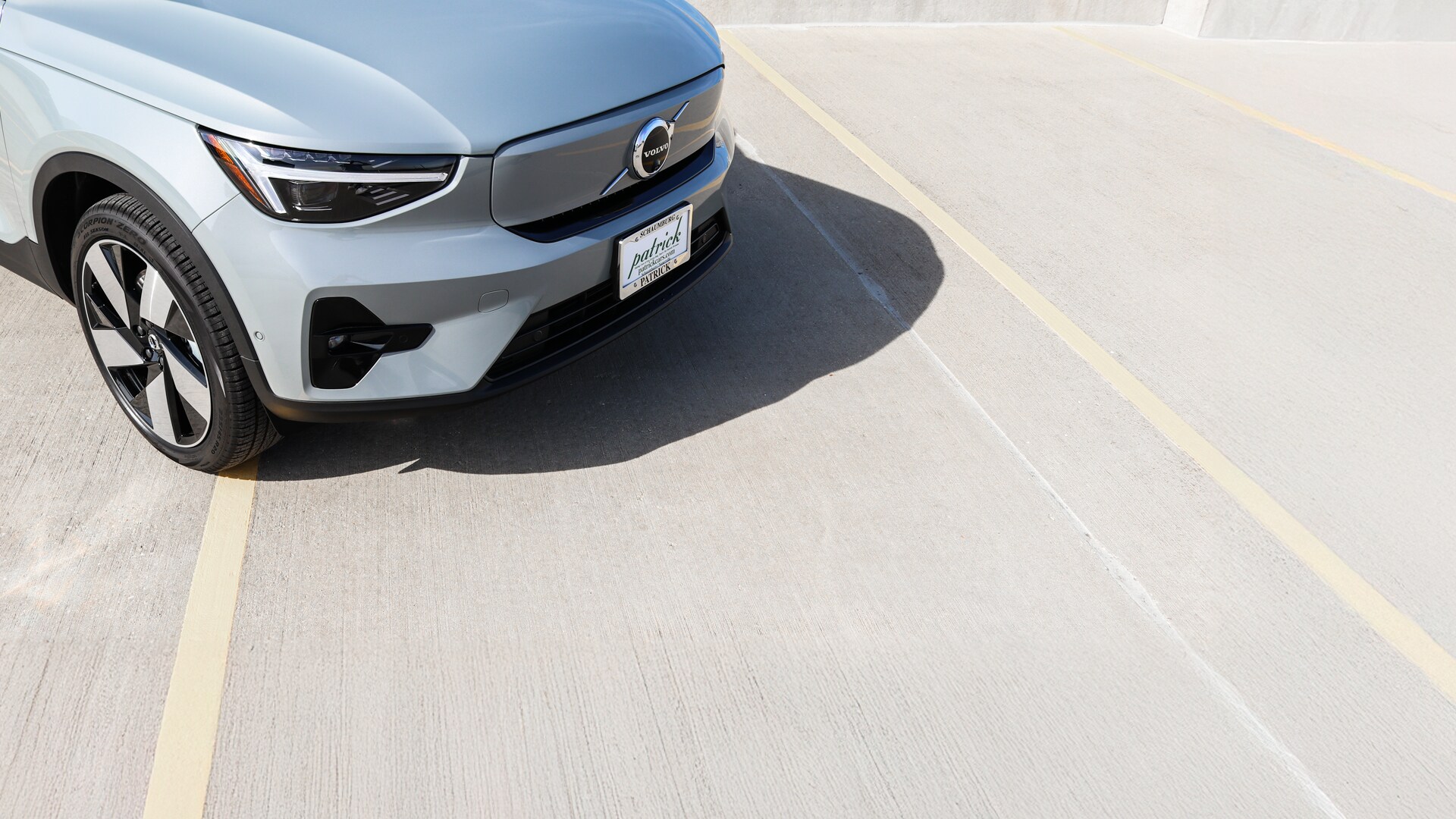 2025 Volvo EX40 front end showcasing the signature Thor's Hammer LED headlights, sleek grille design, and modern aerodynamic styling.