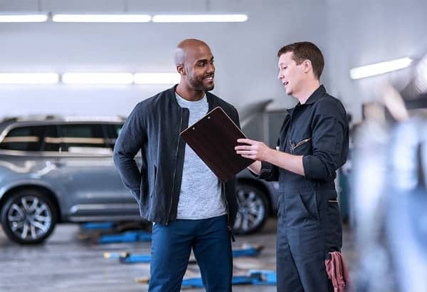 man talks with Volvo technician