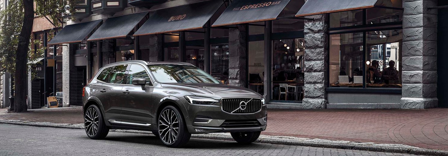 2018 Volvo XC60 parked in front of store fronts