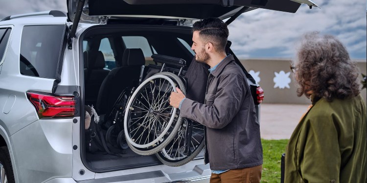 Man Loading a Wheelchair into the Trunk of a Chevrolet car in, Sturgeon Bay