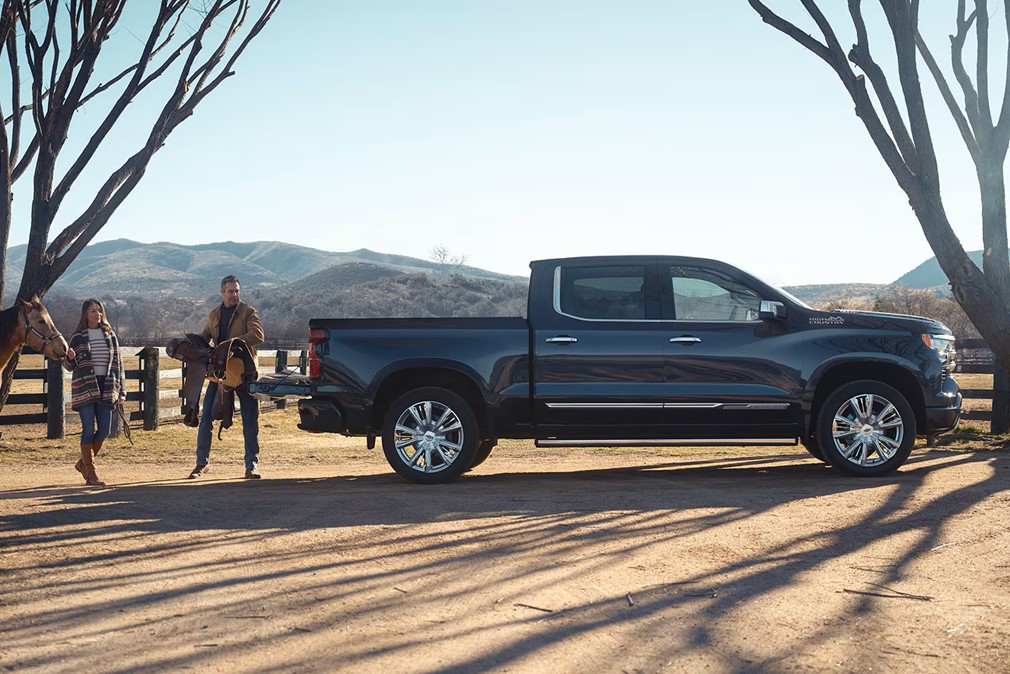 A%20person%20standing%20next%20to%20a%20black%20truck.jpg