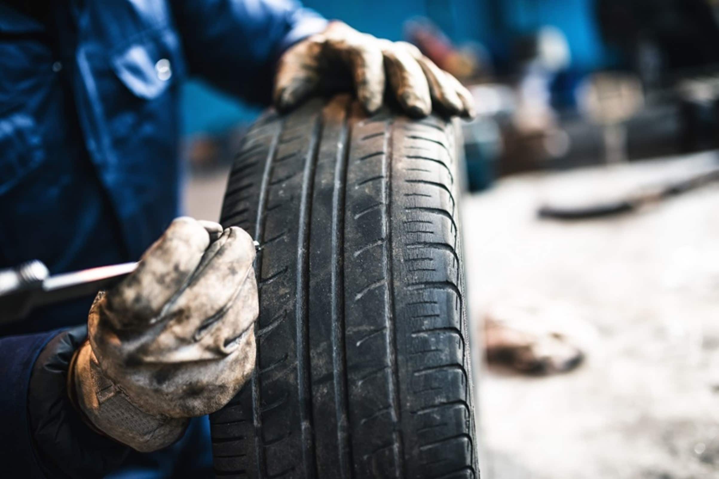 A%20person%20holding%20a%20tire.jpg