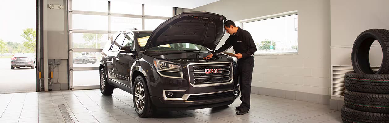 Person servicing a Chevrolet GMC at a service center in Sturgeon Bay, WI