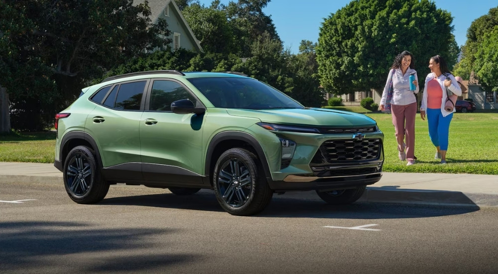 A green 2026 Chevy Trax ACTIV parked near grass.