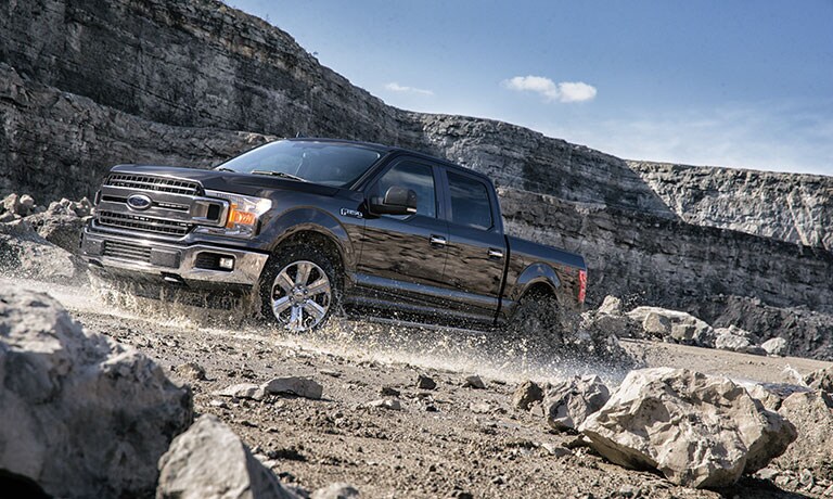 2019 Ford F-150 driving on rocks