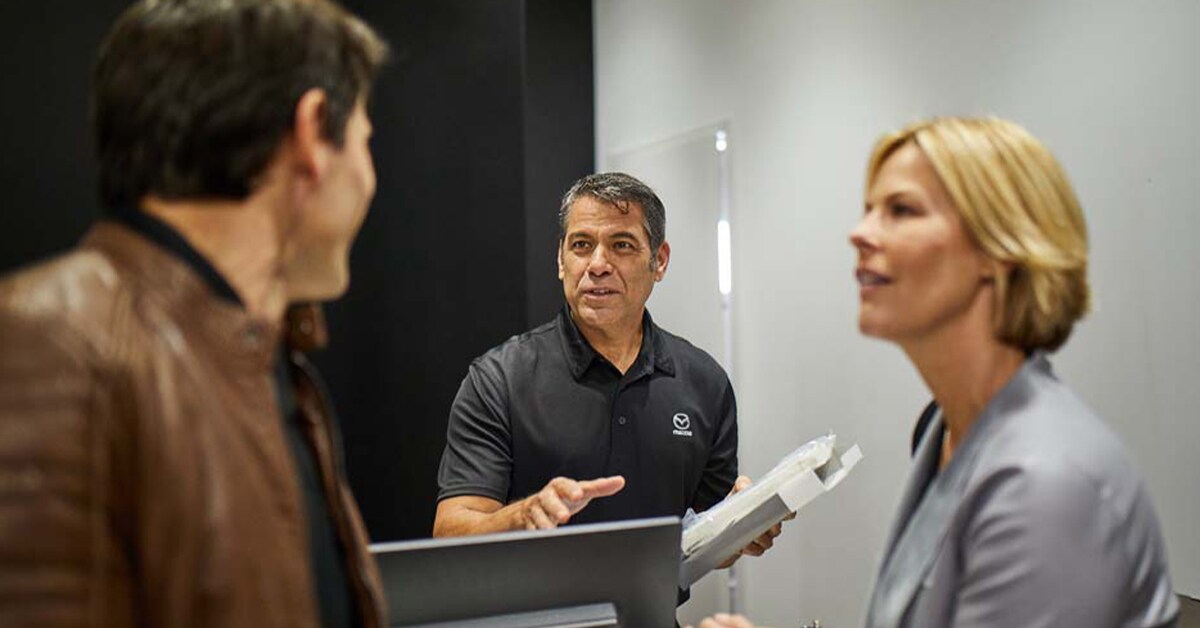 Mazda Customer speaking to service professionals at parts desk