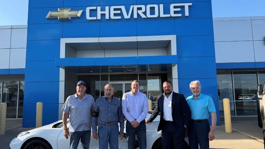 Darryle Bender, Bryce Bender, Brad Bender, Frank Pena and Gary Bender outside Pena Bender Chevrolet in Clovis, New Mexico