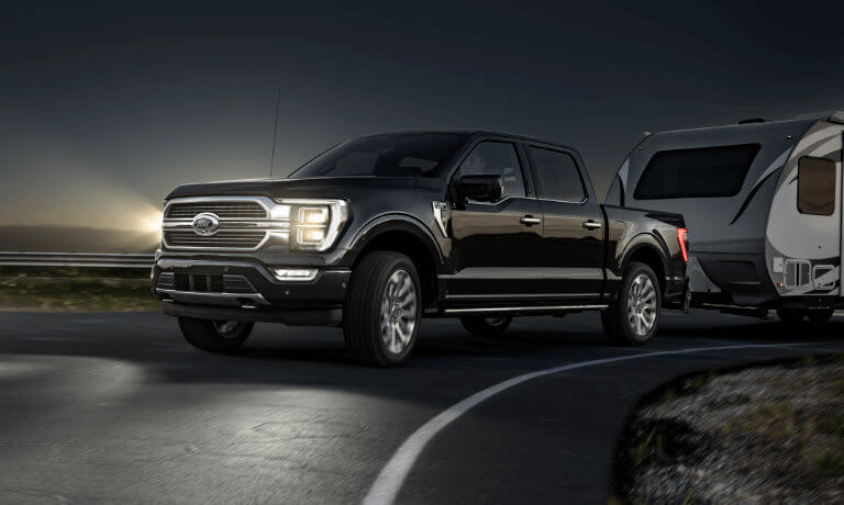2022 Ford F-150 exterior at night towing camper