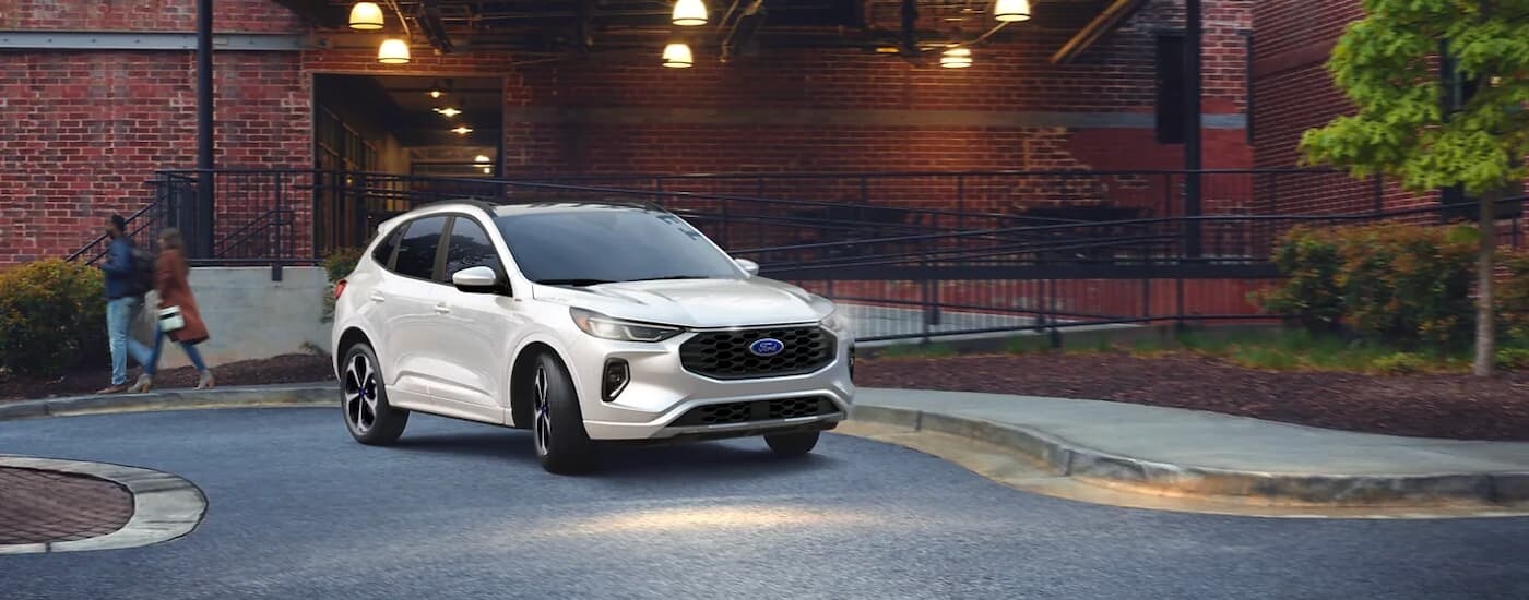 White 2025 Ford Escape parked near a brick building