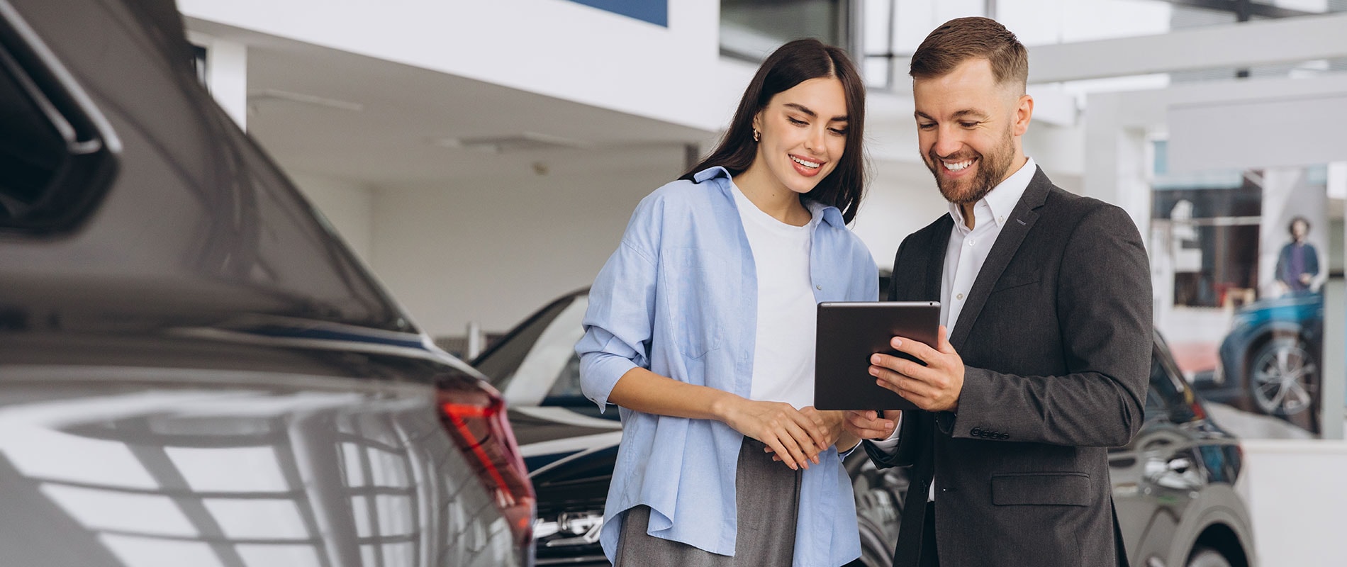 Woman smiling hearing about her ideal used Toyota model