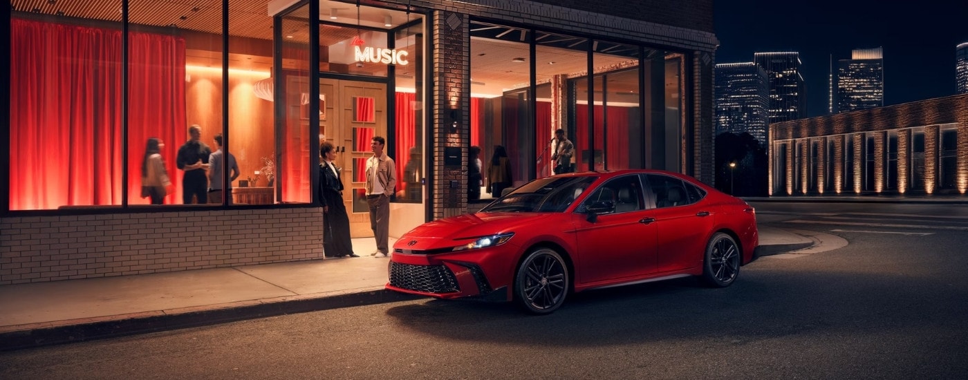 Red 2026 Toyota Camry Nightshade parked in front of a music venue