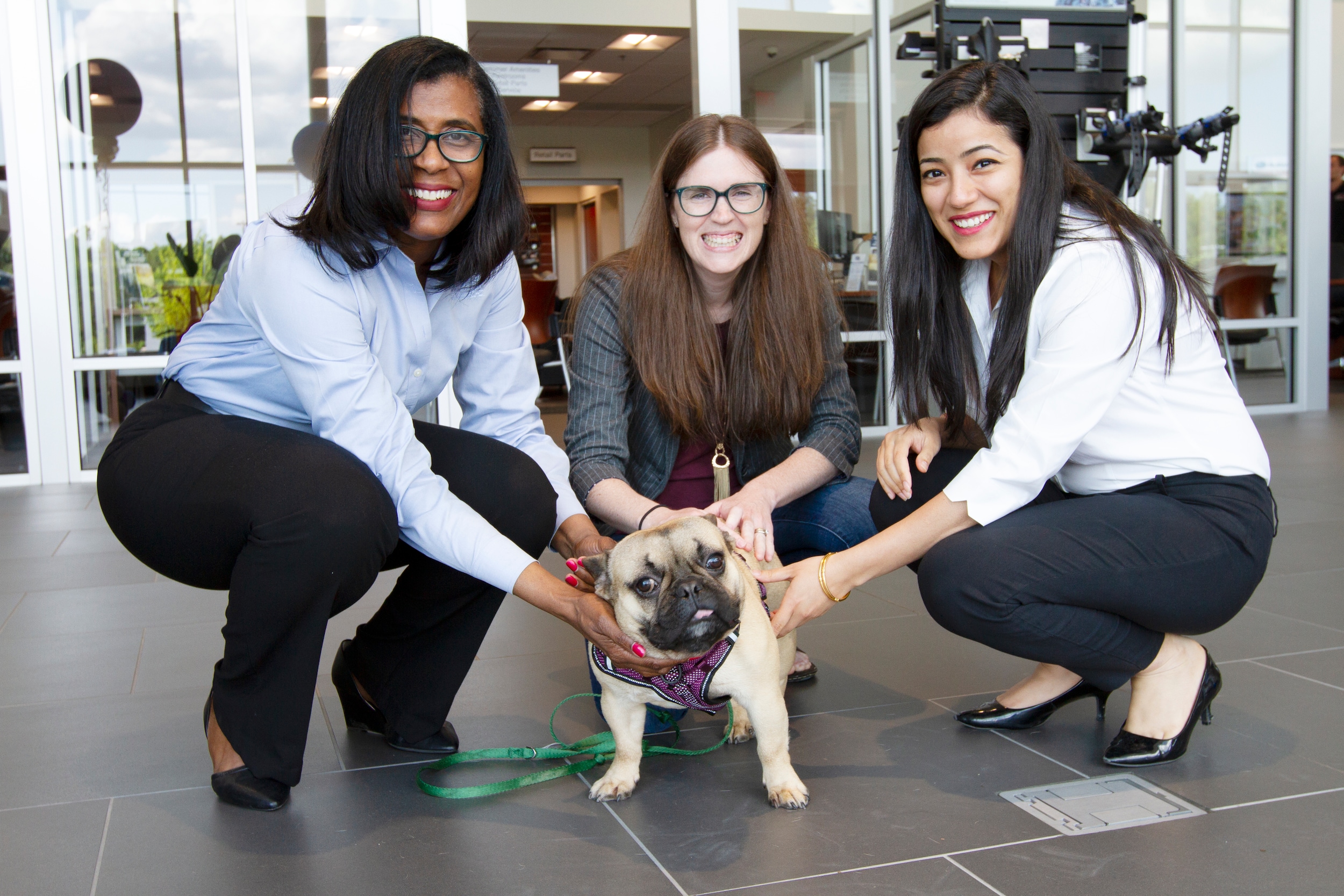 Hendrick Subaru Southpoint General Manager Anna Latta, Marketing Director Poonam Nandani, and Paws4Ever Executive Director Kathryn Ruggeri pose with adorable pug dog.