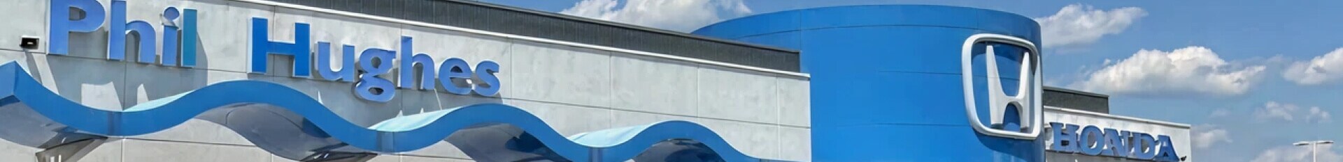 A street view of Phil Hughes Honda on a clear sunny day.