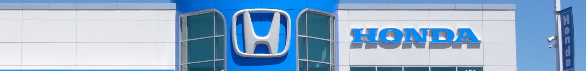 Phil Hughes Honda - a view of the dealership's sign during a clear and sunny day