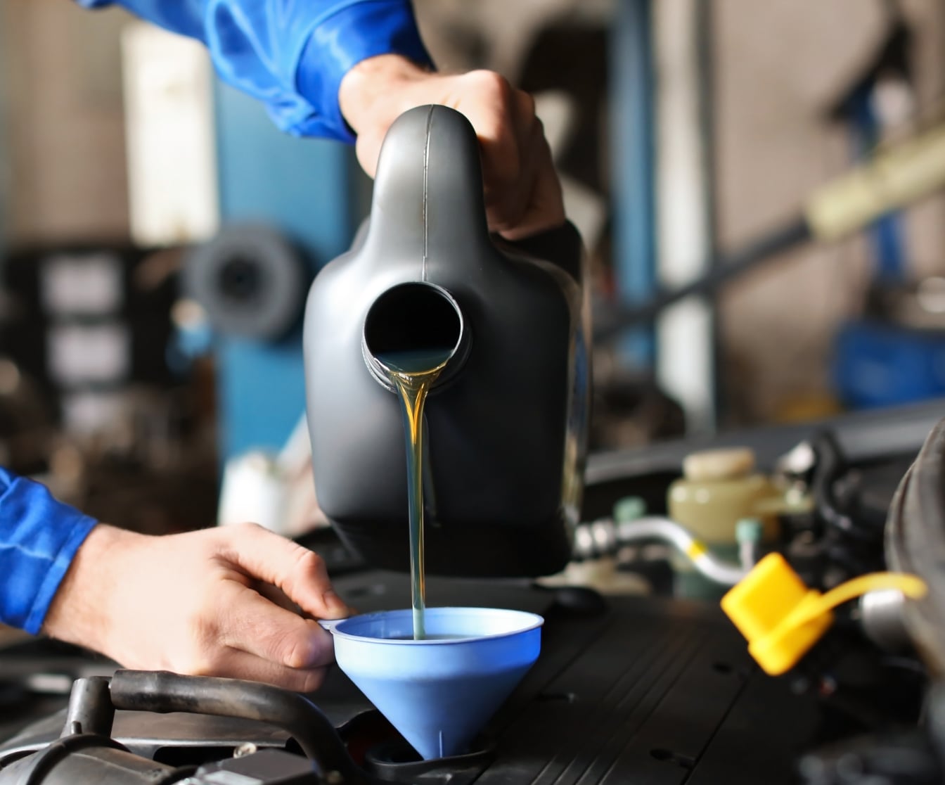Honda technician changing car oil