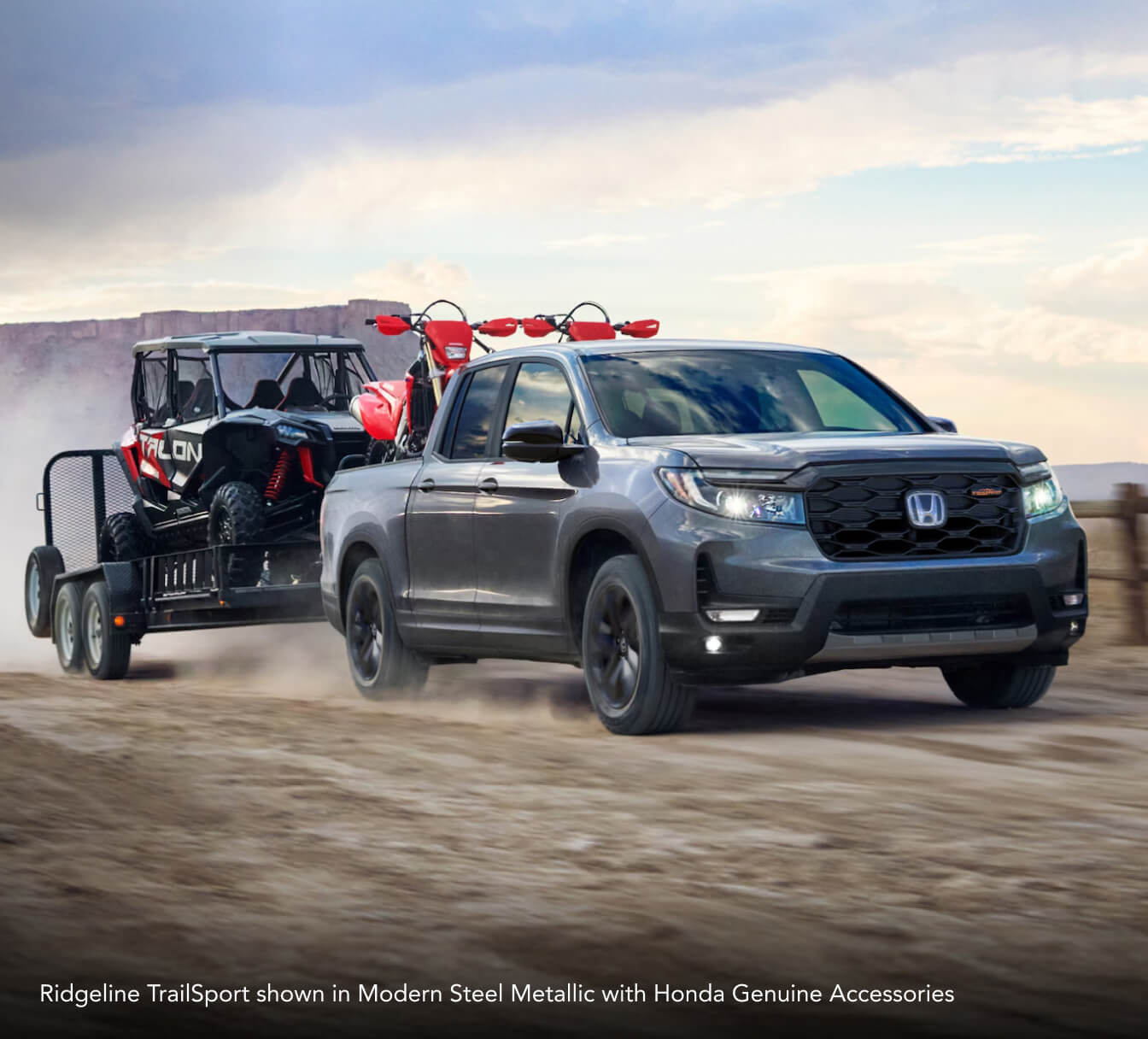Ridgeline TrailSport showin in Modern Steel Metallic with Honda Genuine Accessories driving down a dirt road